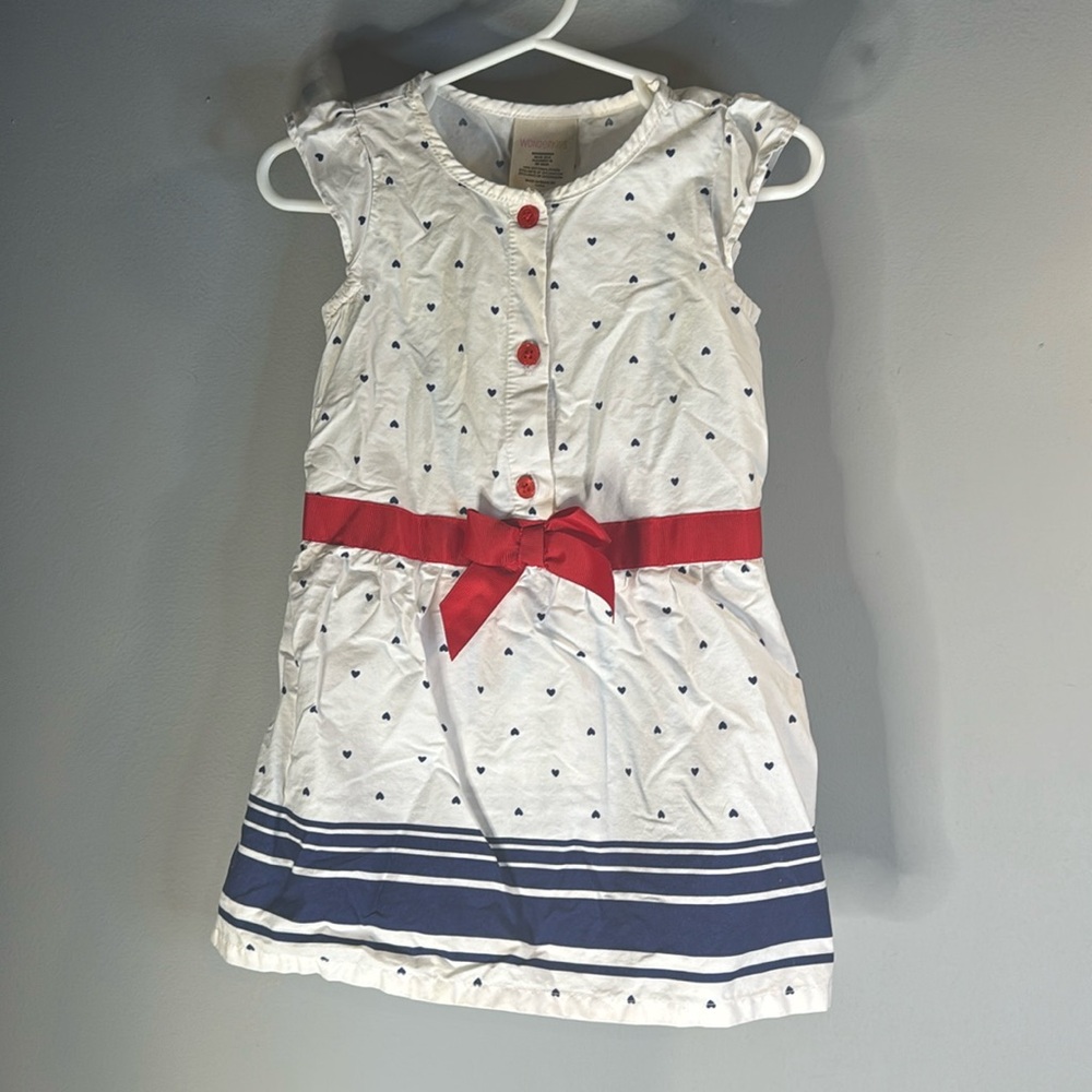 White mini dress with blue hearts and red bow